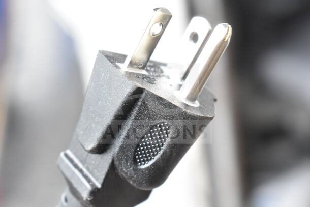 Close-up of a two-prong black power plug, showing texture and detail.