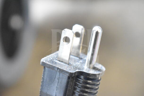 Close-up of an electric plug for the Avantco 177W50CKR countertop food warmer, showing prongs and cable detail.