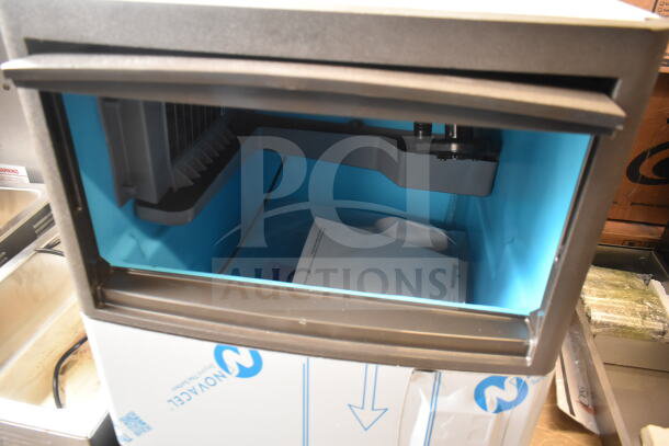 Brand new Manitowoc UDP0065A-161 ice machine, 19 11/16" wide, 31 lb. bin, 62 lb. capacity, visible packaging details.