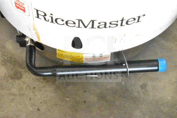 RiceMaster RM-55N-R natural gas rice cooker, 110 cup capacity, visible wear, model label showing "Made in Taiwan".