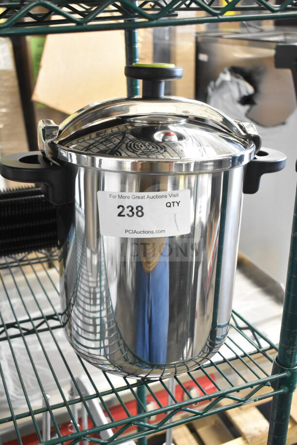 Brand new Monix 013206 stainless steel pressure cooker, 12.66 qt. capacity, minor scratches, tag indicates auction lot 238.