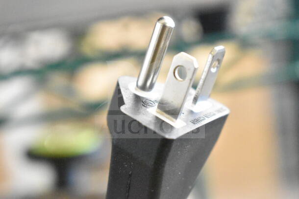 Close-up of Avantco 177IWC35 induction range plug, showing prongs and voltage markings.