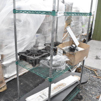 Three-tier green wire shelving unit on commercial casters, includes contents, requires dismantling.