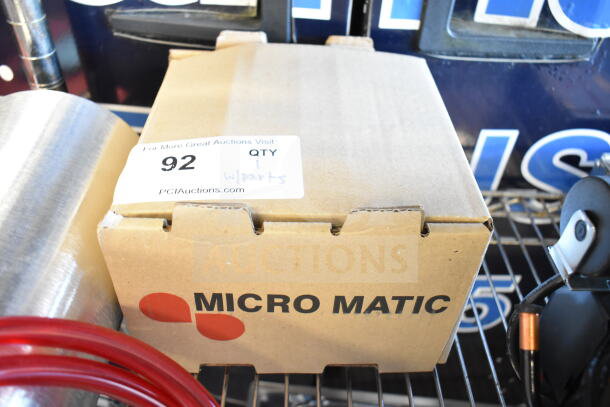 Cardboard box labeled "Micro Matic," containing a Tank with Micro Matic 842-PP Gauge. New scratch and dent item. Tag reads "92, QTY 1 w/parts."