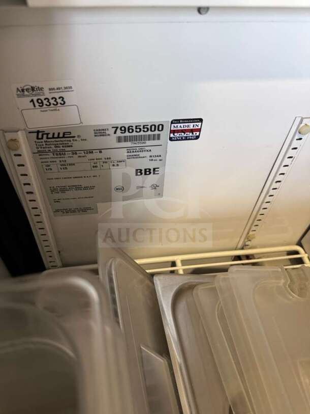 True TSSU-36-12M-B-HC prep table label, model and serial numbers, "Made in USA" sticker, and plastic containers visible.