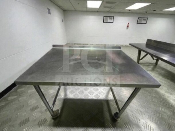 Well-maintained 46" x 30" stainless steel mobile work table with wheels, ideal for commercial use; inspected and ready.