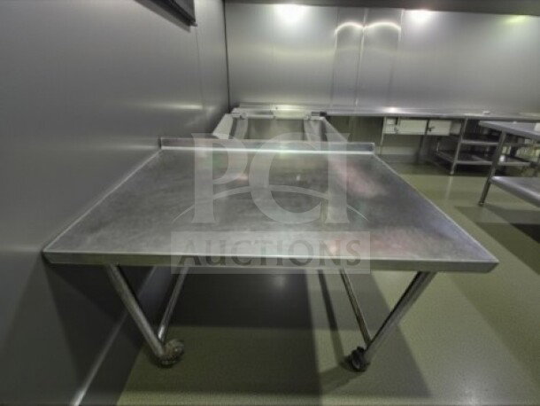 Stainless steel 46" x 30" mobile work table with wheels, unbranded, fully inspected, ready for use, in well-maintained condition.