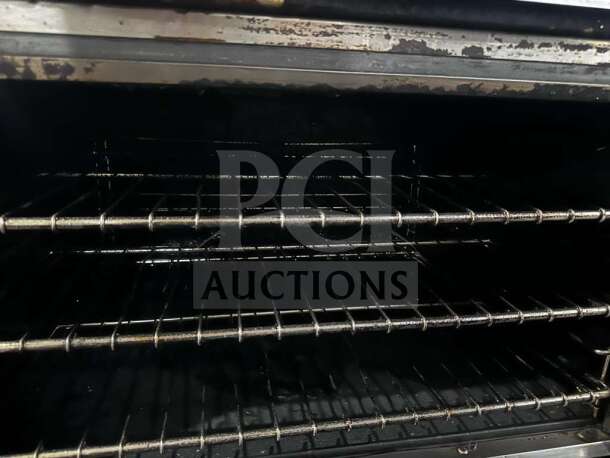Imperial IR-6-C 36" gas range interior with three oven racks, showing minimal wear. Convection oven, fully operational.