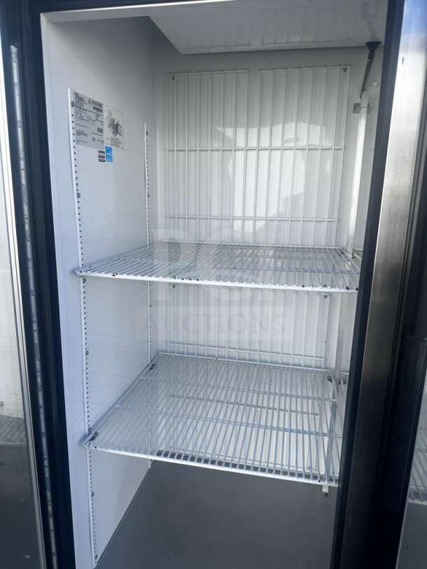 True GDM-49F-LTF-HC~TSL01 freezer merchandiser in superior condition, black glass door, LED lighting, 8 shelves, 115V, NSF/UL listed.