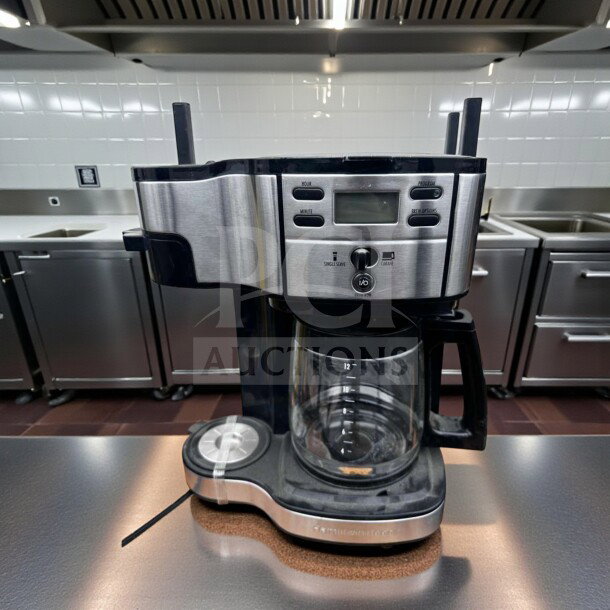 Brand new 12-cup programmable drip coffee machine, stainless steel and black finish, glass carafe, single serve option.
