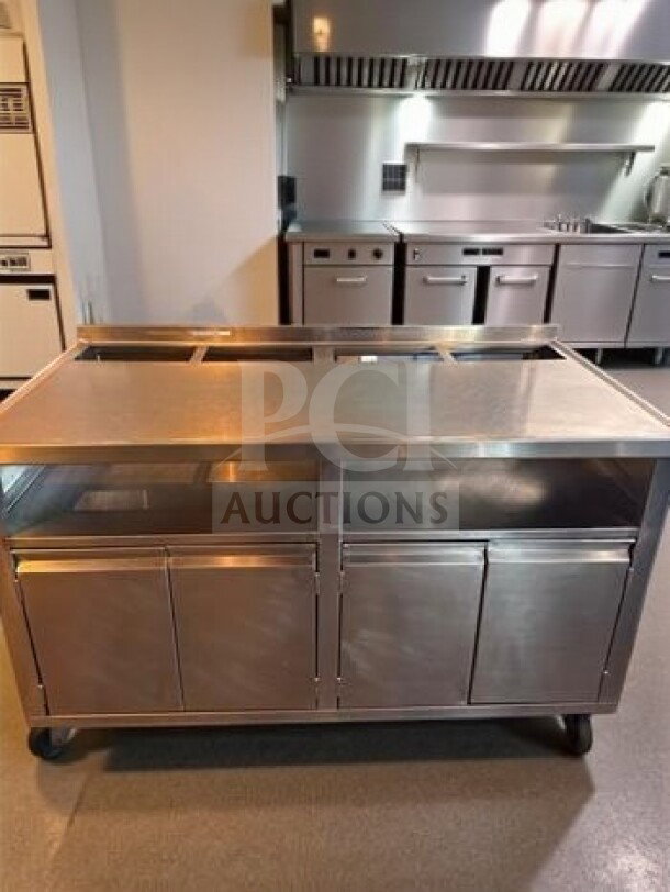 Stainless steel work table with under cabinet storage, 57"x31"x38", mobile, exceptional condition, fully inspected.