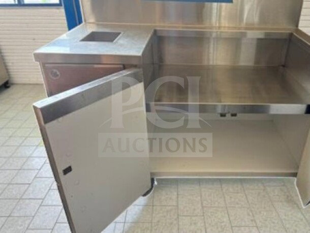 Stainless steel commercial dish bussing station, 52" x 26" x 42", with cabinet storage and open door, excellent condition.