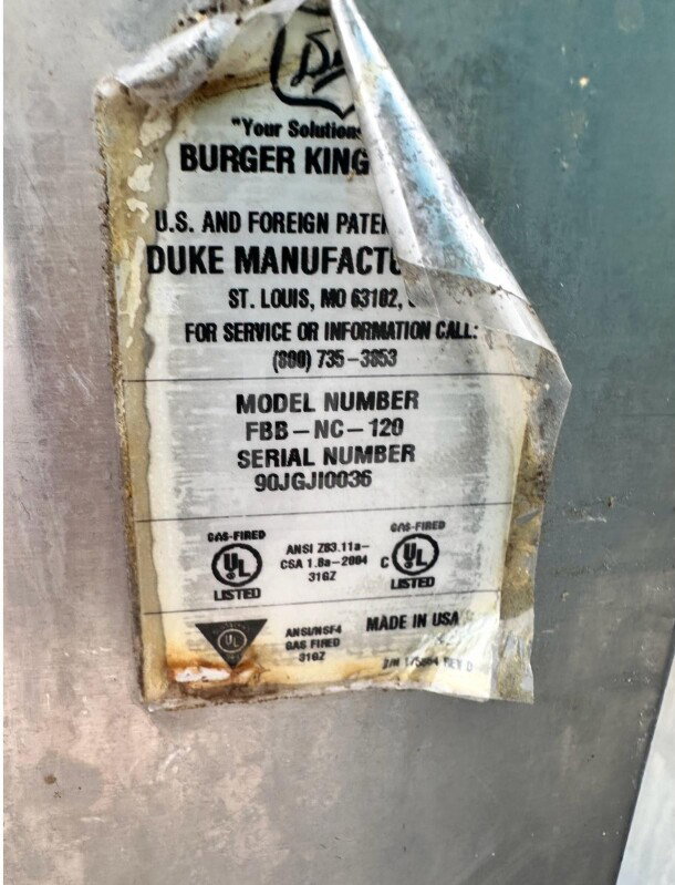 Tag on Duke FBB-NC-120 gas conveyor broiler, showing model and serial numbers, UL listed for safety compliance.