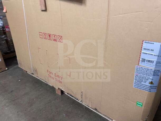 KoolMore RD32C-SS refrigerated display case in box. Brand new, stainless steel, ETL listed, model tag visible.