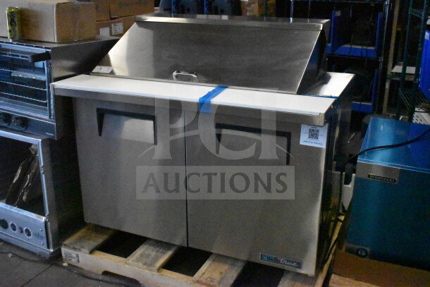 Brand new True TSSU-48-18M-B-HC sandwich salad prep table, Mega Top design, 115 volts, slight exterior scratch, visible label.