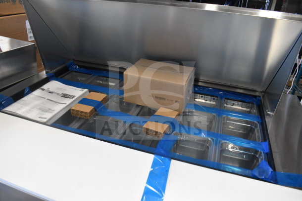 Brand new True TSSU-48-18M-B-HC sandwich prep table, visible protective packaging, scratch and dent, 115V, 1 phase.