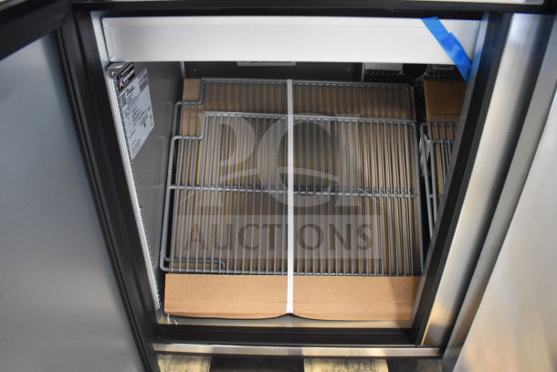 Brand new True TSSU-48-18M-B-HC prep table interior. Scratch and dent condition, visible label with model details.
