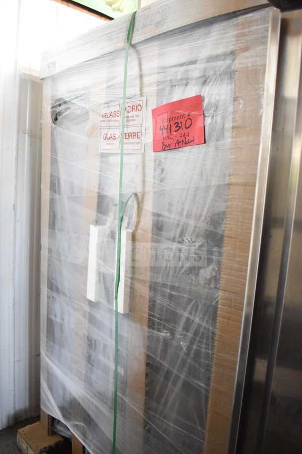 True TVM-48SL-HC 2 Door Reach In Cooler, new with minor scratches, wrapped for shipment. 115V, 1 Phase. Labels indicate shipment details.
