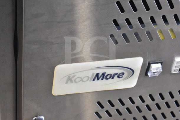 KoolMore commercial refrigerated granite top pizza prep station with vent details and logo visible. Stainless steel finish.