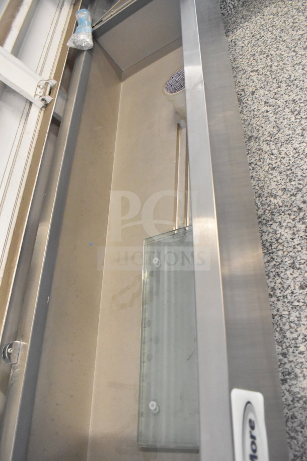 KoolMore KM-RPPS-2D59-GRT 59" refrigerated pizza prep station with granite top and stainless steel condiment pan holder.