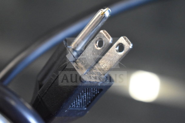 Close-up of a three-prong plug for the KoolMore SCDC-6P-SSL refrigerated countertop condiment prep station, 115 volts.