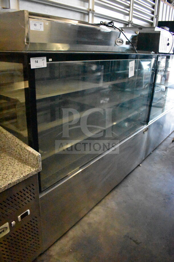 Brand new KoolMore commercial deli display case, glass-front, stainless steel body, tags indicate scratch and dent condition.