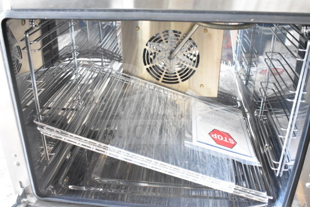 Brand new KoolMore KM-CTCO-23STI countertop convection oven with 4 racks, 2800W, and steam injection. Scratch and dent marked.