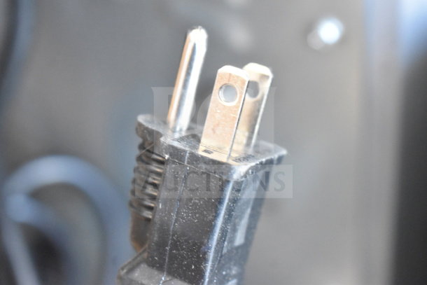 Close-up of the plug for a KoolMore KM-CTCO-15 countertop convection oven. Plug shows standard three-prong design.