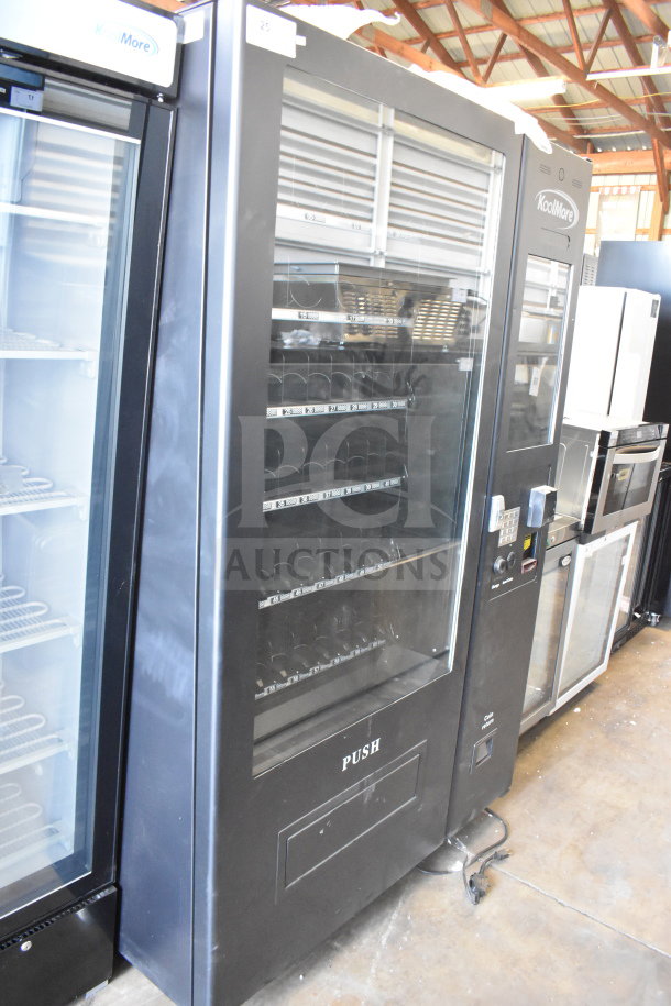 Brand new KoolMore commercial vending machine, scratch and dent condition, spacious display shelves, labeled for prices.