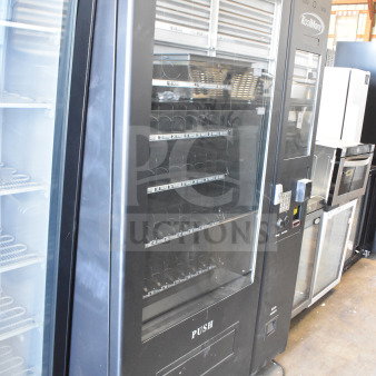 Brand new KoolMore commercial vending machine, scratch and dent condition, spacious display shelves, labeled for prices.