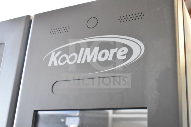 Brand new KoolMore commercial vending machine with minor scratches and dents. Brand logo visible on front panel.