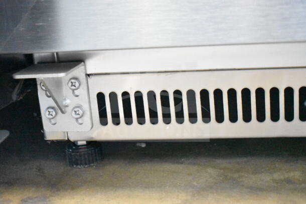 KoolMore KM-MDF46GD 24" commercial countertop freezer, 4.6 cu. ft., scratch and dent, metal vent and adjustable foot visible.