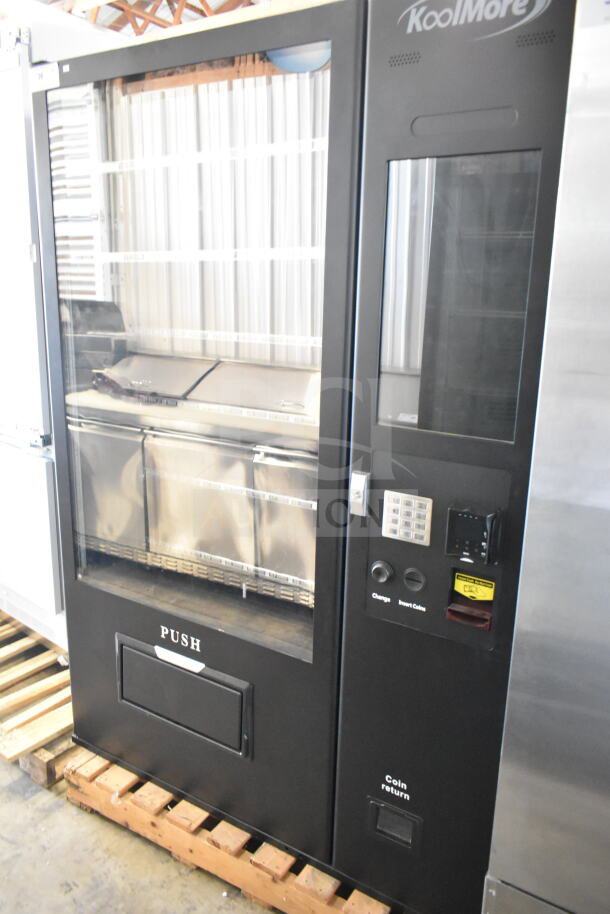 Brand new KoolMore commercial vending machine with slight scratches and dents. Coin and note acceptor, keypad visible.