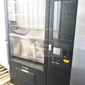 Brand new KoolMore commercial vending machine with slight scratches and dents. Coin and note acceptor, keypad visible.