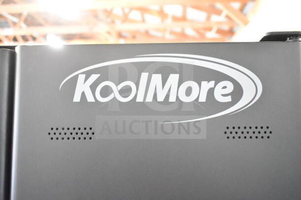KoolMore commercial vending machine, brand new with minor scratches and dents, black finish, features visible KoolMore logo.