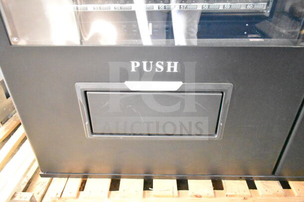 BRAND NEW SCRATCH AND DENT KoolMore Commercial Vending Machine, black, durable, visible "PUSH" label, on wood pallet.