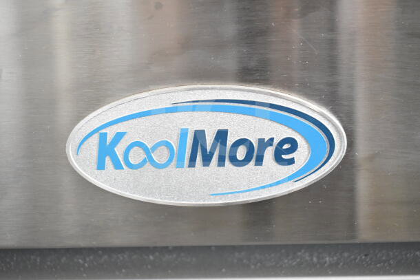 KoolMore logo on stainless steel surface of a commercial kitchen appliance.