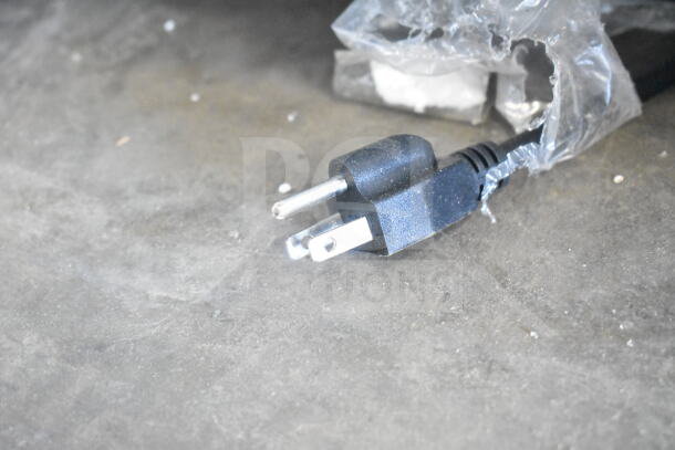 Power plug wrapped in plastic for the KoolMore CDC-3C-WH countertop display refrigerator, indicating a new condition.