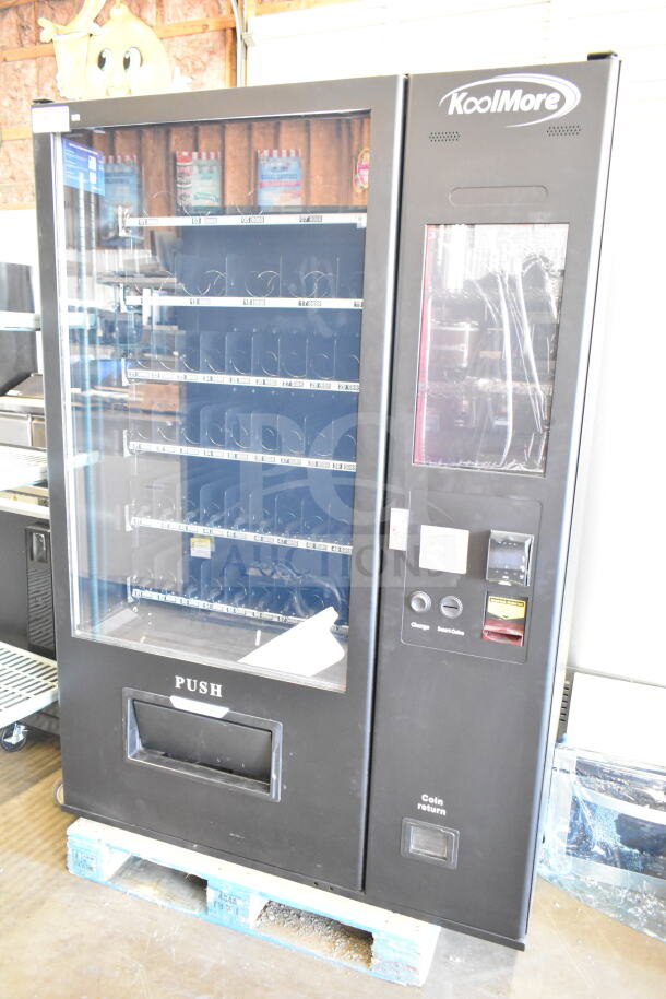 Brand new KoolMore commercial vending machine with minor scratches and dents. Features keypad, coin slot, and display window.