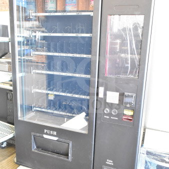 Brand new KoolMore commercial vending machine with minor scratches and dents. Features keypad, coin slot, and display window.
