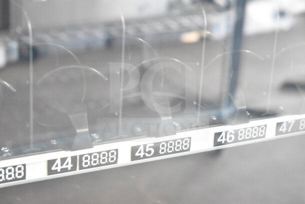 KoolMore commercial vending machine, brand new with scratch and dent, showing coil slots and digital display.