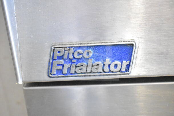 Pitco Frialator logo on a commercial gas-powered deep fat fryer, showing stainless steel surface.