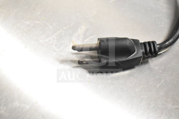 Black power plug on a stainless steel commercial prep table, part of Ascend Jimex JSP-7218 model.