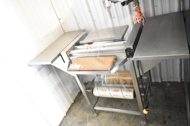 Commercial floor-style wrapping station with Hobart scale, label printer, 115 volts, 1 phase. Appears in used condition.