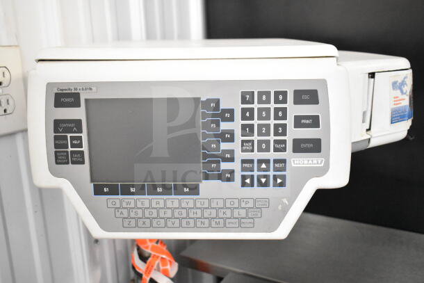 Commercial wrapping station with Hobart scale and label printer. Features a digital display, keypad, 115V, 1 Phase.