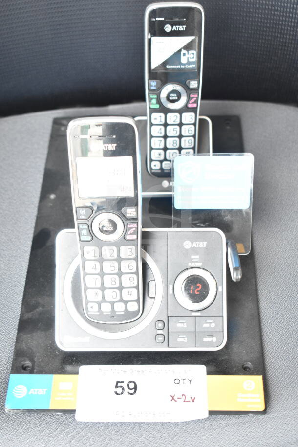AT&T store display with two cordless phones in cradles; features numeric pads, call block, and display screens; item 59.