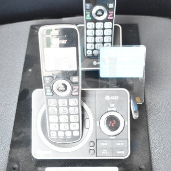 AT&T store display with two cordless phones in cradles; features numeric pads, call block, and display screens; item 59.