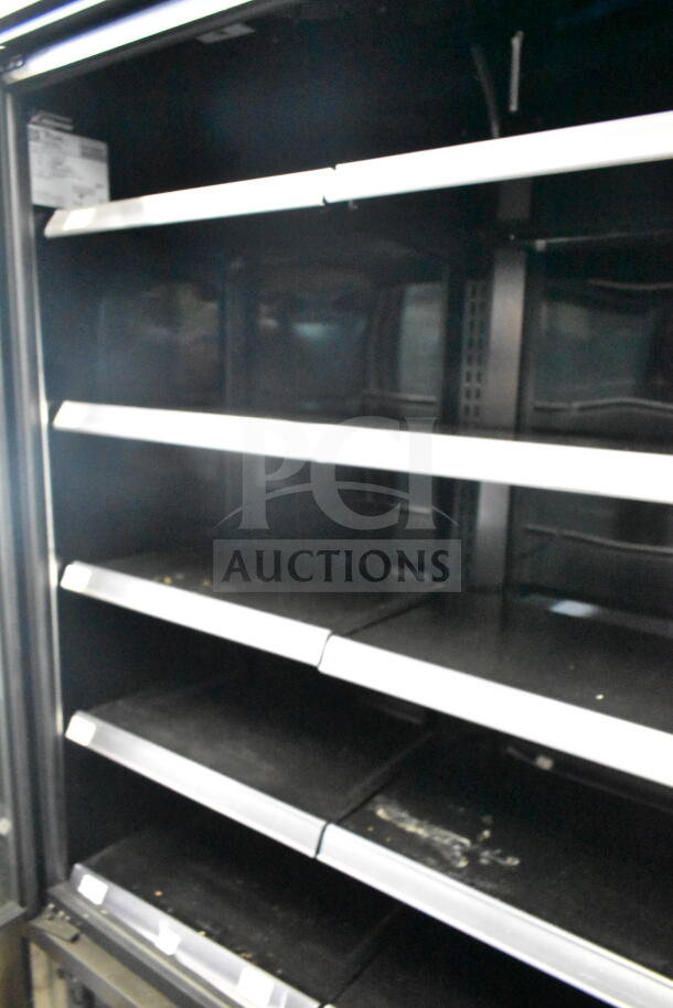 2022 True TVM-48SL-HC 2 Door Reach In Cooler Merchandiser with shelves. 115 Volts, 1 Phase. Used condition.