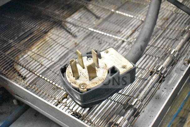 Turbochef Commercial Conveyor Rapid Cook Oven plug on wire rack, showing 208/240V electric connector.