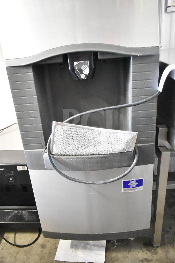 Manitowoc commercial ice head on hotel ice dispenser, stainless steel, visible logo, moderate wear, with power cord.